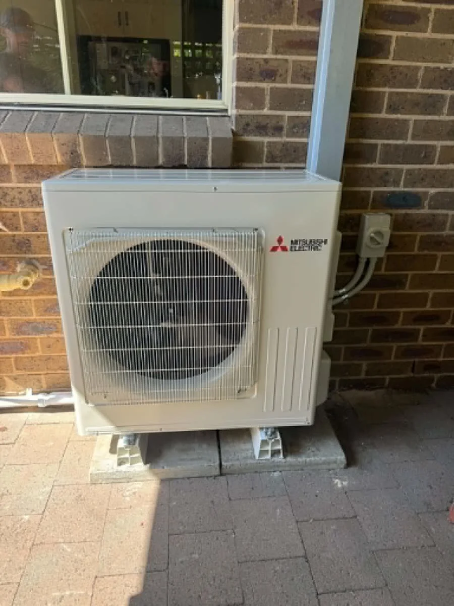 Split system outdoor unit against a brick wall